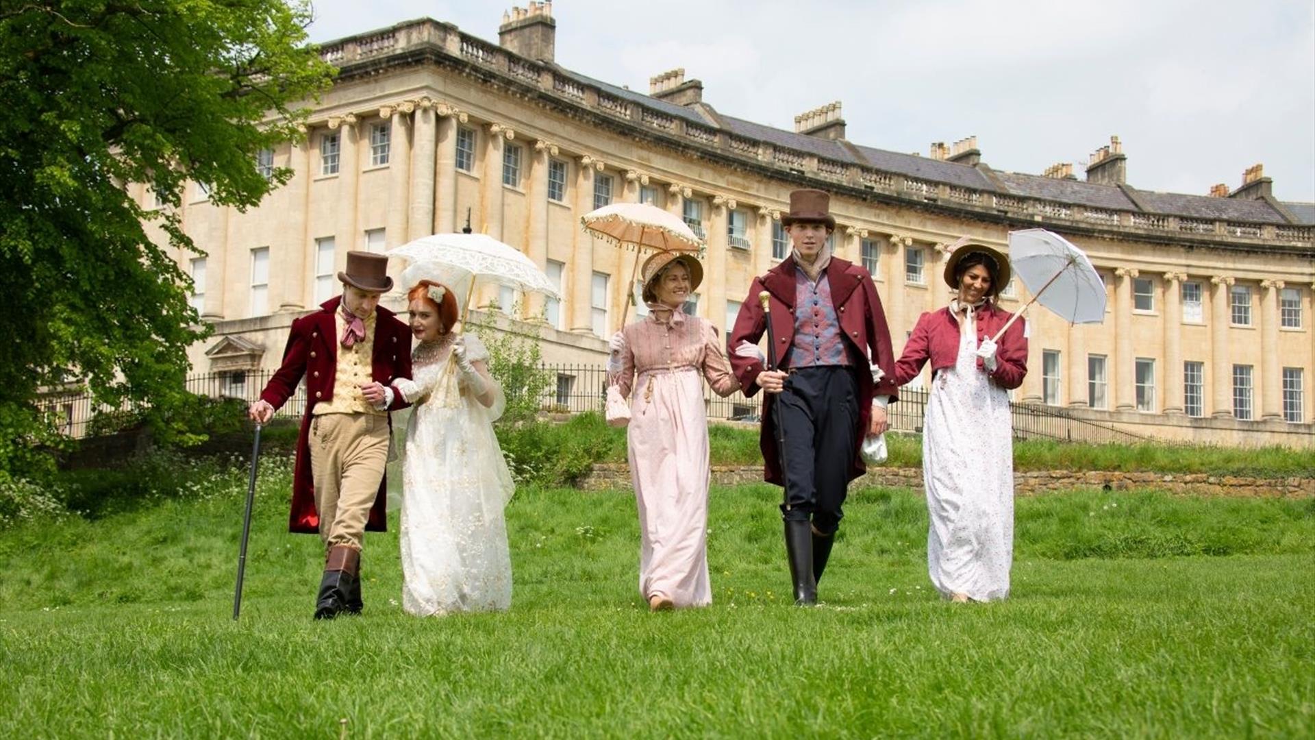 Costumed walkers on the lawn below the Royal Crescent, Bath